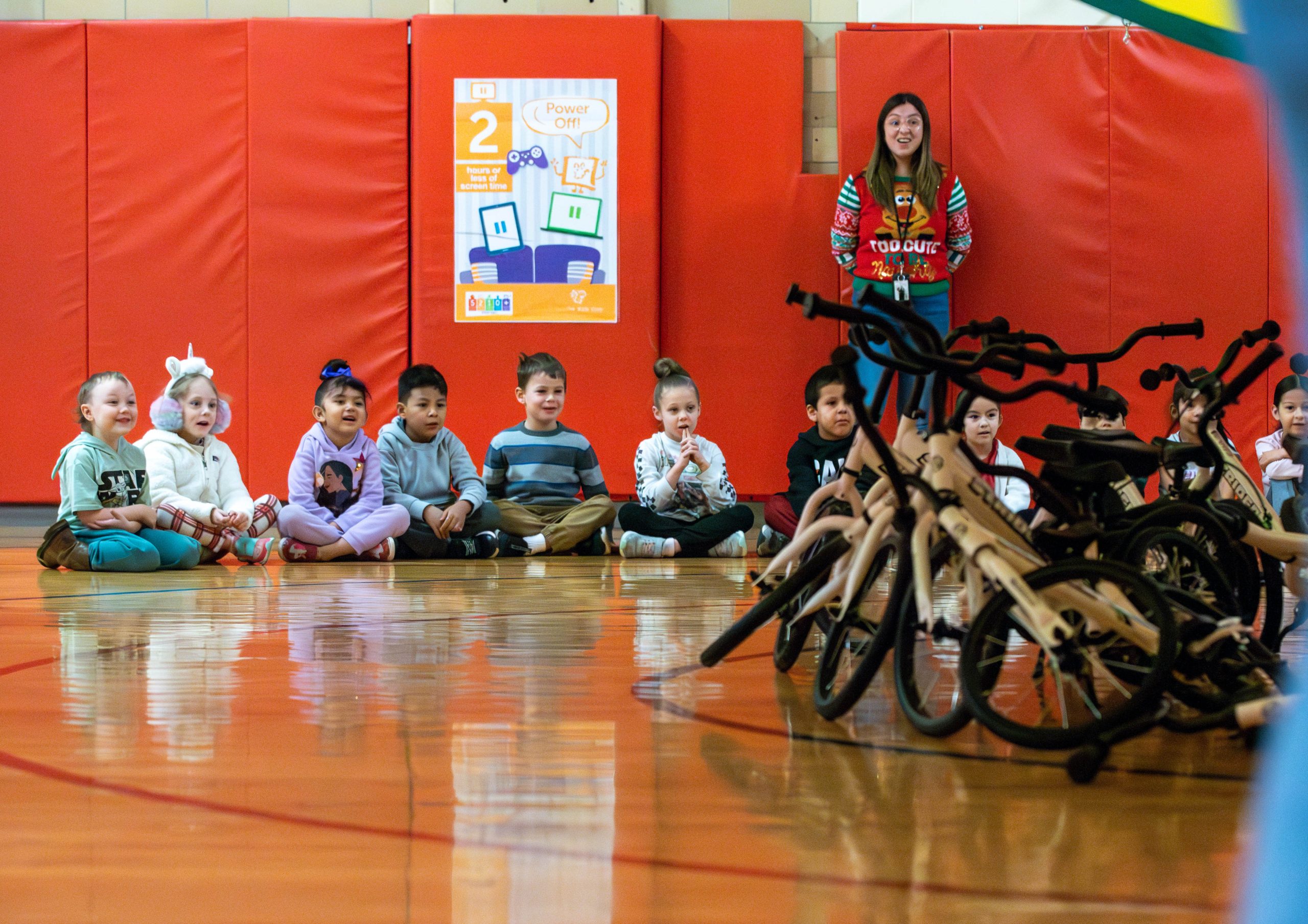 Columbine kindergartners sitting in front of bike-cycles
